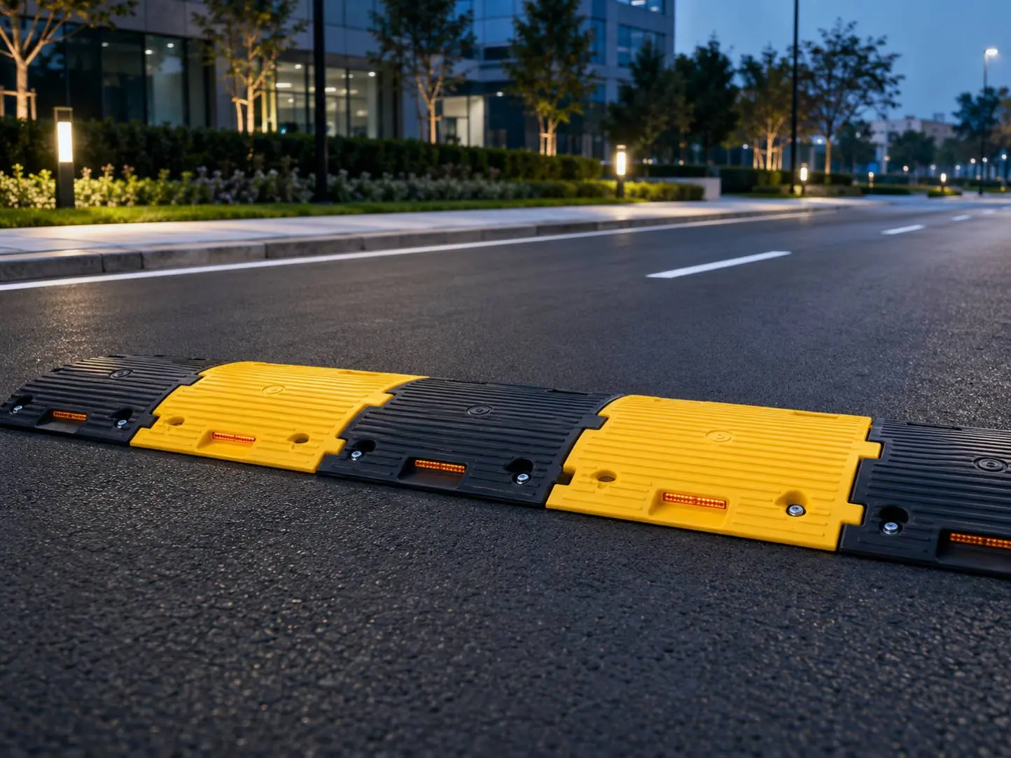 Black and yellow modular speed breaker on a roadway
